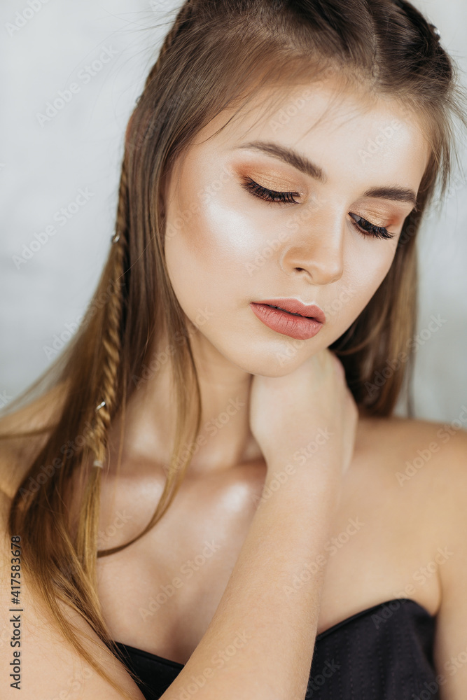 Fashion model portrait Beautiful brunette on a light background with closed eyes, portrait of a girl with make-up. Fashion model portrait Beautiful brunette on a light background with closed eyes, portrait of a girl with make-up.