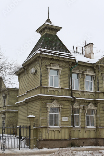 Ancient wooden house with ornamental windows, carved frames of merchant Sapozhnikov on Simanovsky Street, 14 (Sverdlova, 63), Kostroma city, Russia. Russian style in architecture. Kostroma landmark photo