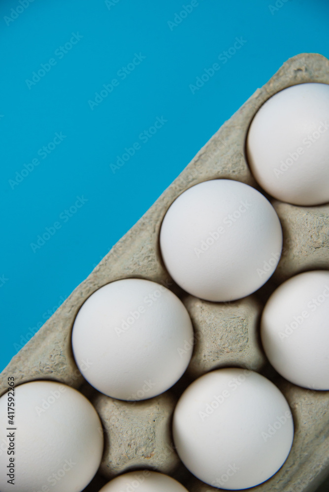 Eggs in a package on a blue background