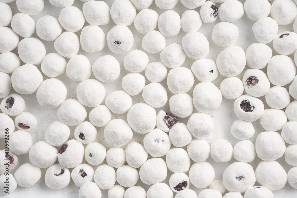 Cranberries in powdered sugar close-up. Cranberries in powdered sugar close-up.