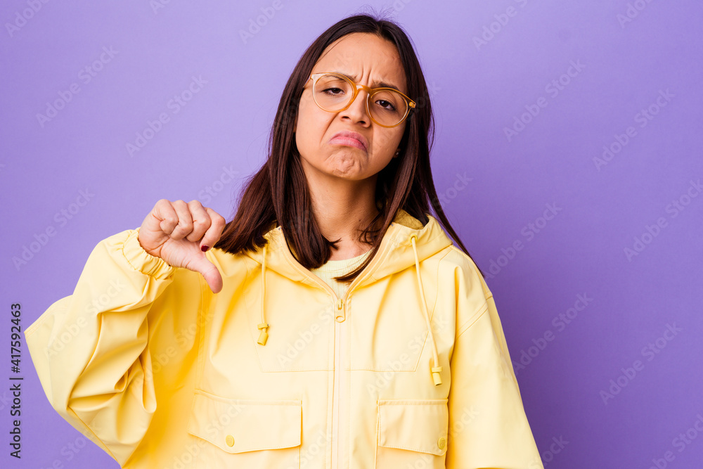 Young mixed race woman isolated showing a dislike gesture, thumbs down. Disagreement concept. Young mixed race woman isolated showing a dislike gesture, thumbs down. Disagreement concept.