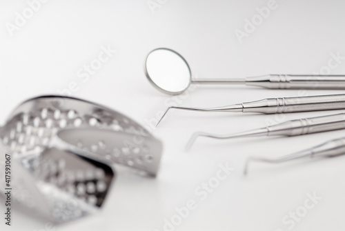 Basic dentist tools on white table.
