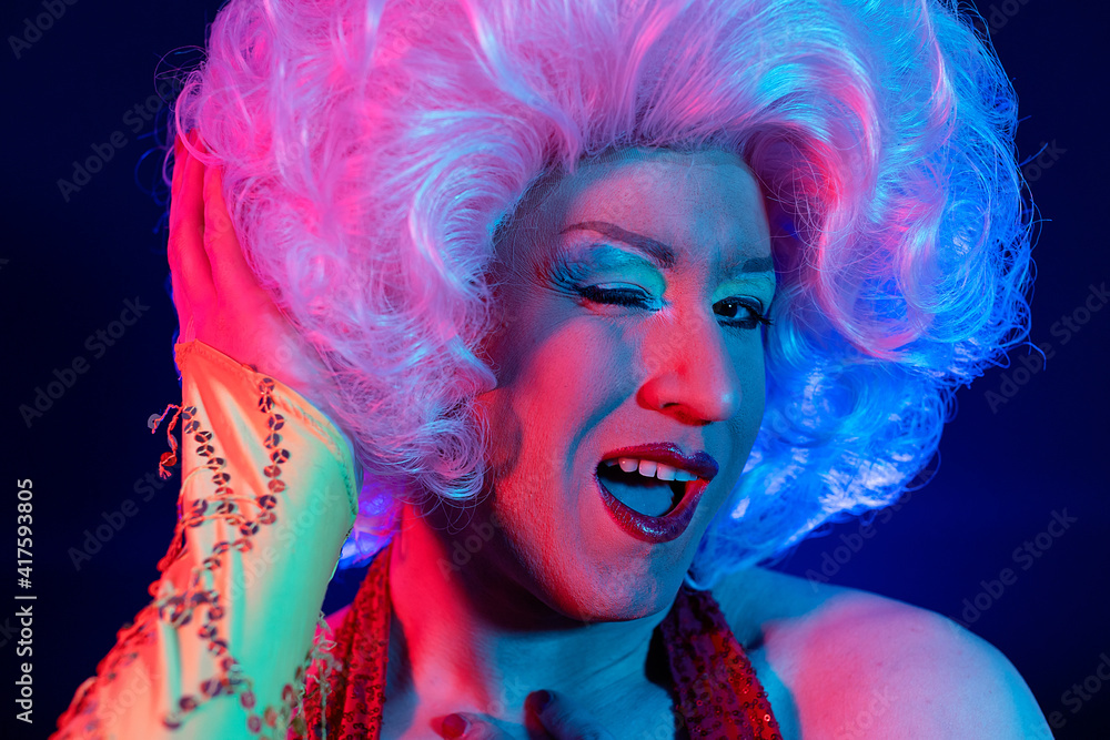 closeup photo studio portrait with gel lights of a transvestite gay man