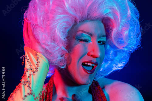 closeup photo studio portrait with gel lights of a transvestite gay man photo