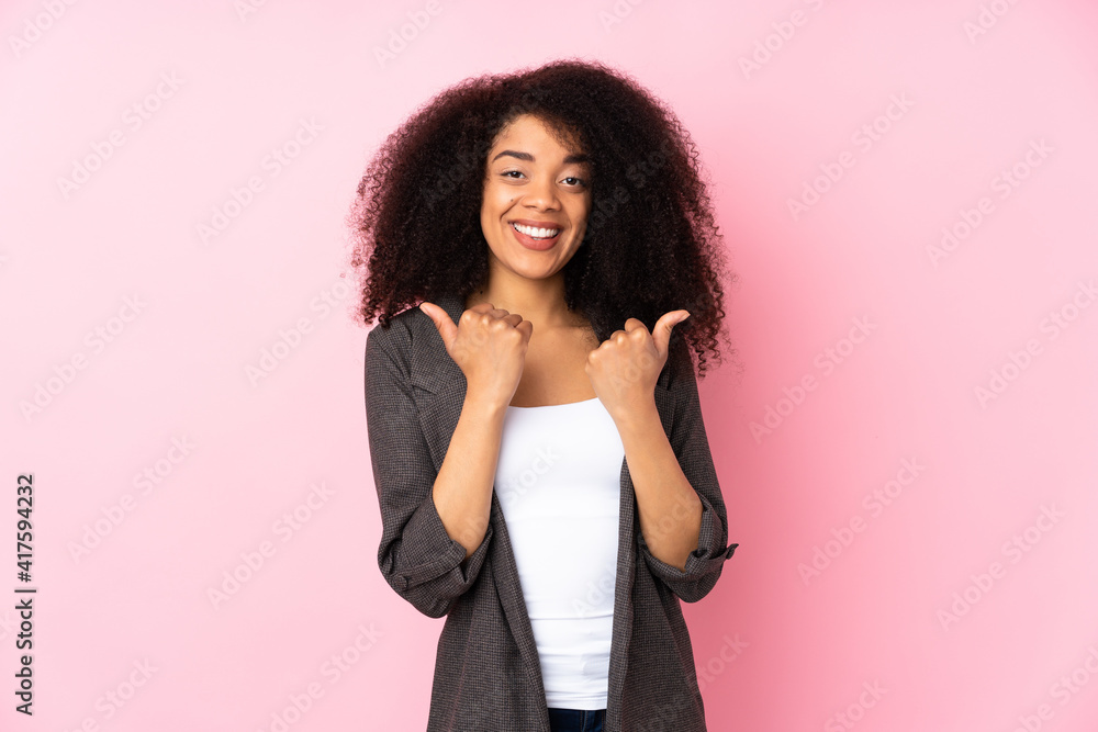 Young african american woman over isolated background with thumbs up gesture and smiling Young african american woman over isolated background with thumbs up gesture and smiling