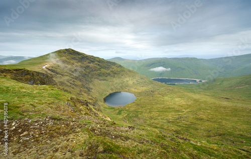 The summit of Stuc an Lochain with Lochan nan Cat below and Loch Daimh n the distance in the Scottish Highland mountains, UK landscapes. photo