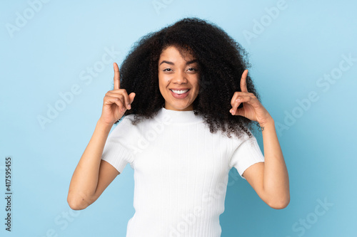 Young african american woman over isolated background pointing up a great idea