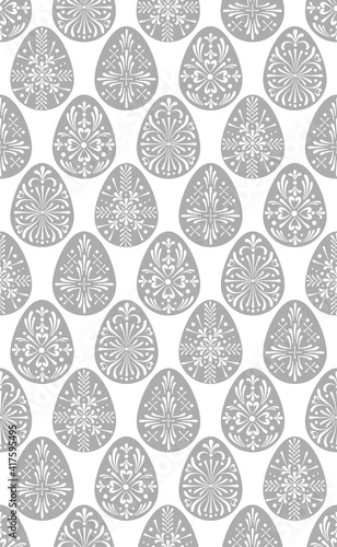 Easter folksy eggs seamless vector pattern. Illustration of decorative neutral grey Easter eggs for textile or wrapping surface. Traditional Easter ornament for Christian spring holidays.