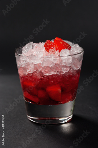 Strawberry cocktail with crushed ice on a red gradient