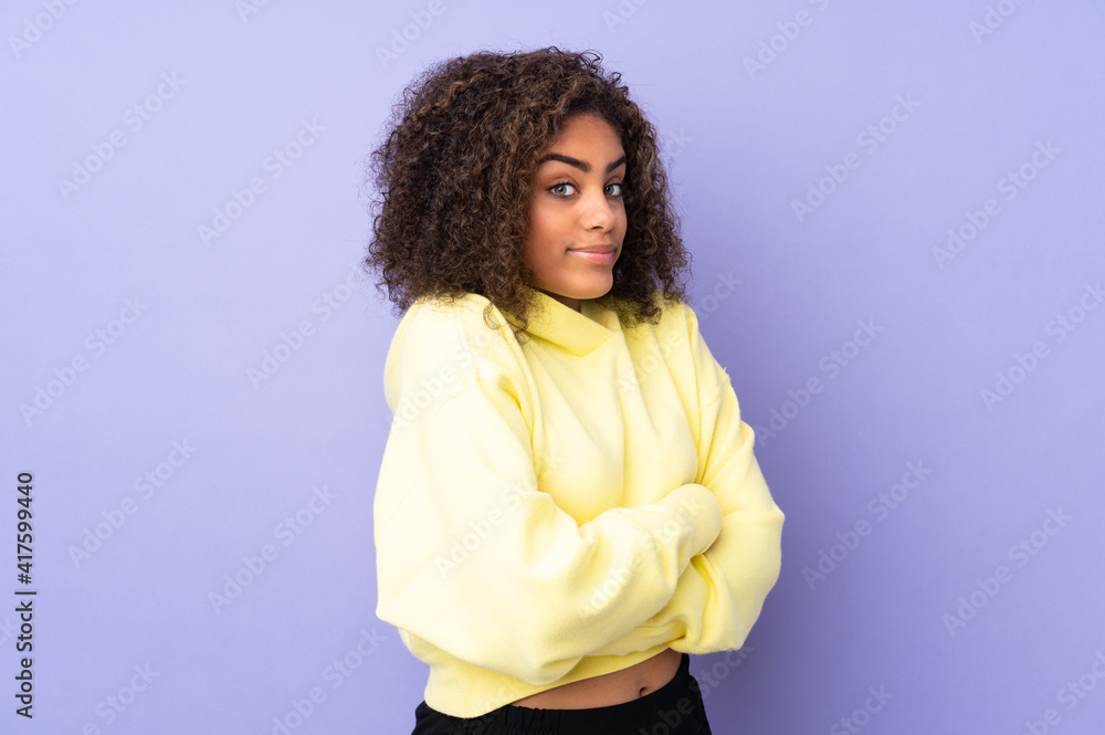 Young African American woman isolated on background making doubts gesture while lifting the shoulders Young African American woman isolated on background making doubts gesture while lifting the shoulders
