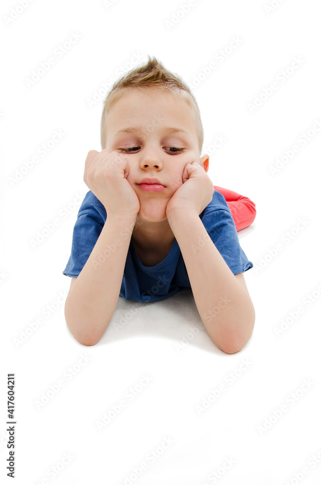 Little boy feels annoyed grumpy lying on the floor. Isolated on white background
Little boy feels annoyed grumpy lying on the floor. Isolated on white background