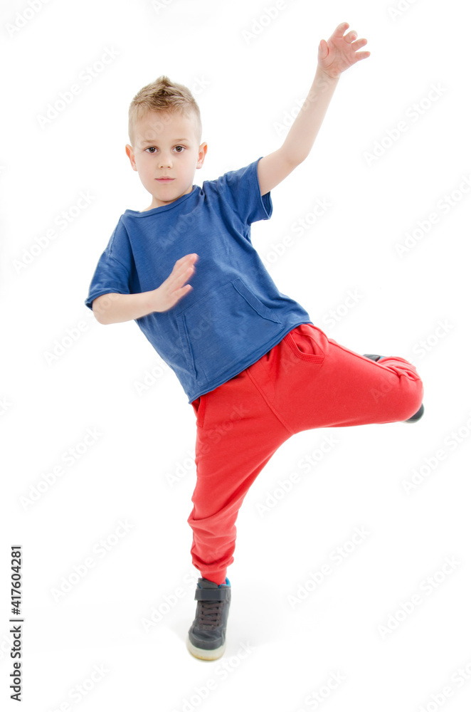 Little cool hip-hop boy in dance. Isolated on white background
Little cool hip-hop boy in dance. Isolated on white background