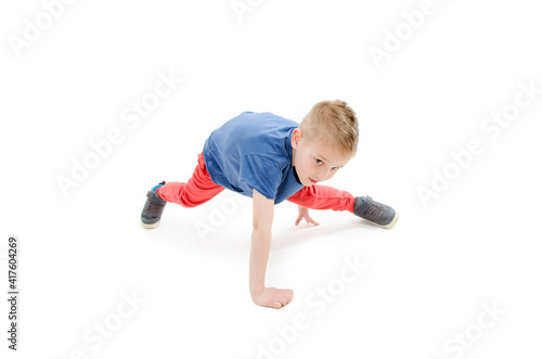 Little cool hip-hop boy in dance. Isolated on white background
