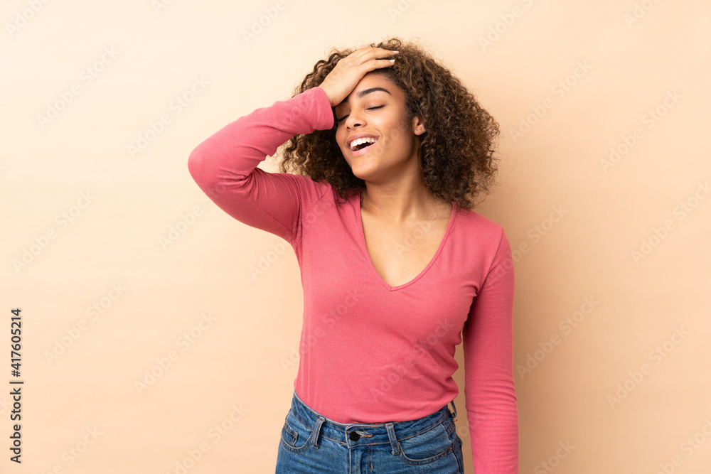 Young African American woman isolated on beige background has realized something and intending the solution Young African American woman isolated on beige background has realized something and intending the solution