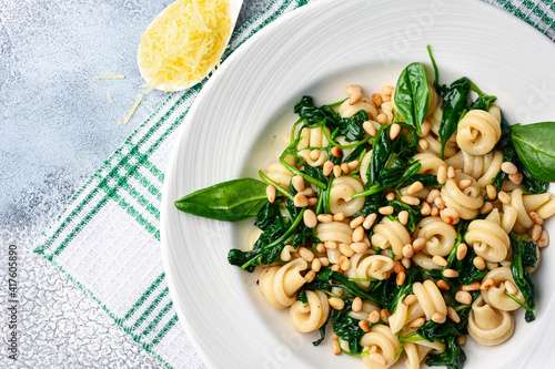 Funghetti pasta with spinach, pine nuts and parmesan. photo