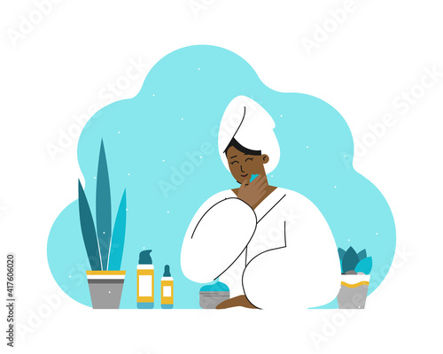 Vector isolated concept with smiling African American young woman in bathroom, wearing in towel and bathrobe. Skin care routine. Using cosmetic products as face cream, moisturizing serum. Flat design