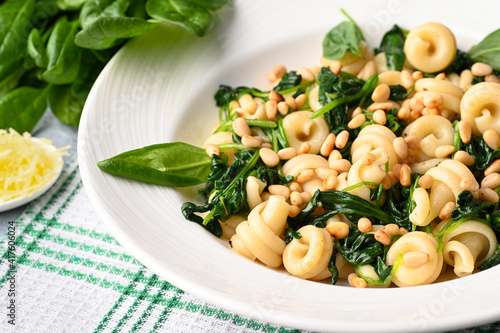 Funghetti pasta with spinach, pine nuts and parmesan. photo