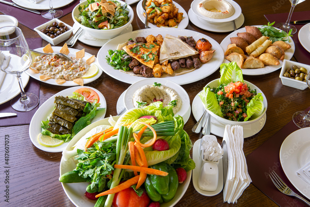 Table with various arabic food served in a restaurant. Table with various arabic food served in a restaurant.