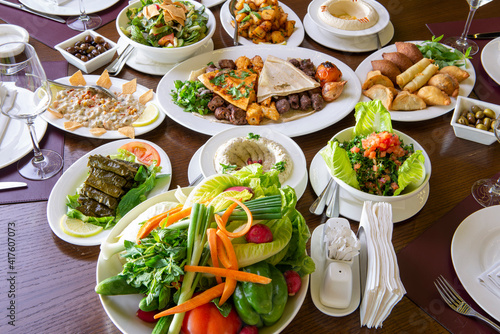 Table with various arabic food served in a restaurant.