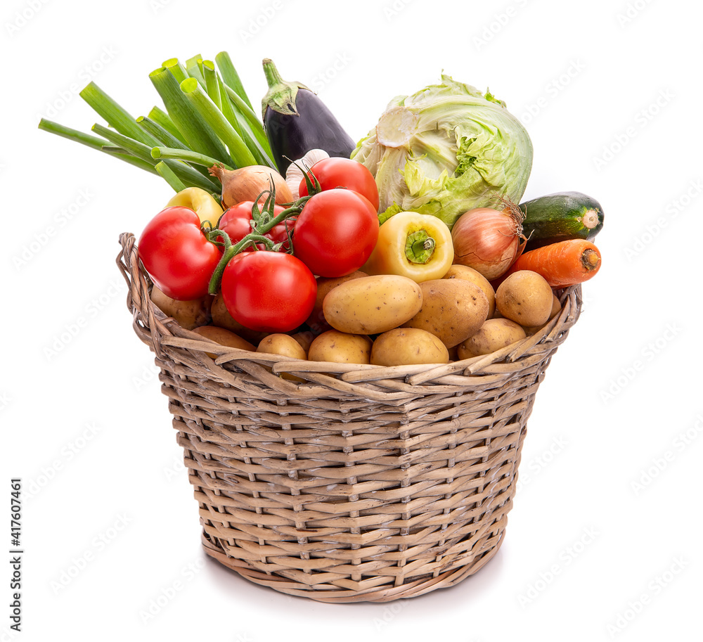 Large basket of vegetables. Potatoes, tomatoes, onions, cabbage, paprika, zucchini, eggplant. Isolate on white background