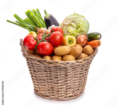 Obraz na płótnie Large basket of vegetables. Potatoes, tomatoes, onions, cabbage, paprika, zucchini, eggplant. Isolate on white background w salonie