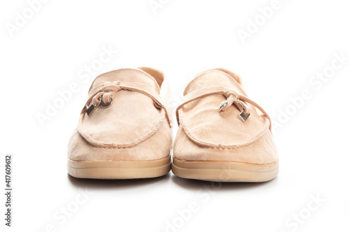 Pair of beige modern unisex loafers on white background