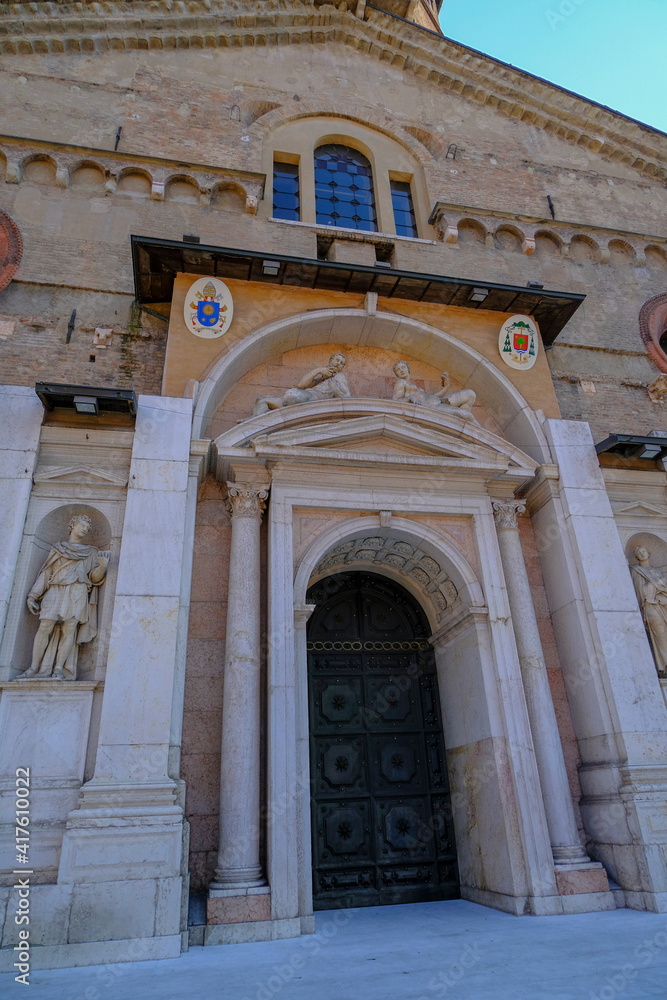 October 2020 Reggio Emilia, Italy: Entrance of the Cathedral, Cattedrale di Santa Maria Assunta in sunlight. Square piazza Prampolini 
