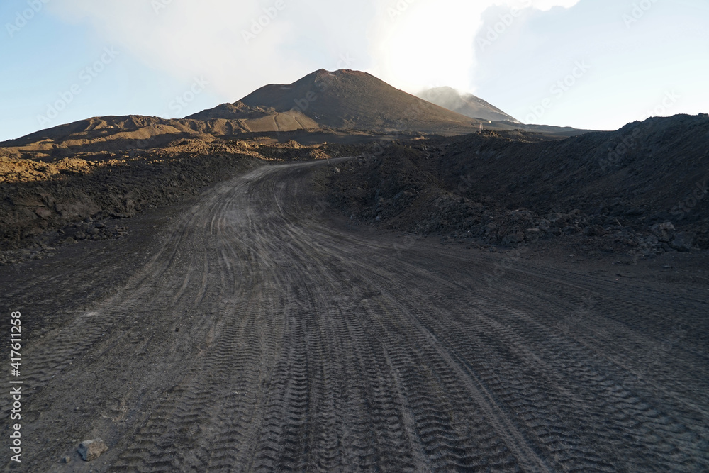 Mount Etna road for 4wd trucks and cars, Etna summit and crater with dangerous volcanic activity trek hiking guided tour concept, Sicily, Italy Mount Etna road for 4wd trucks and cars, Etna summit and crater with dangerous volcanic activity trek hiking guided tour concept, Sicily, Italy