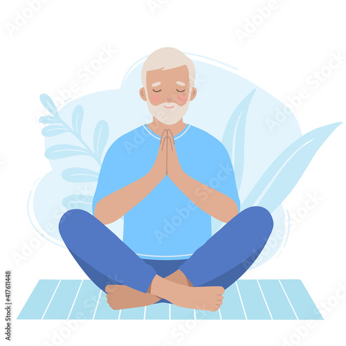 Mature older man practicing zen pose on a yoga mat.