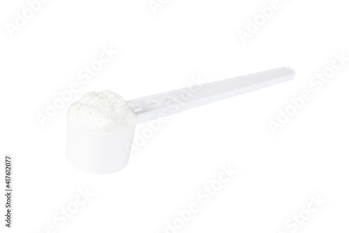 close up of powdered milk and spoon for baby on isolated white background 