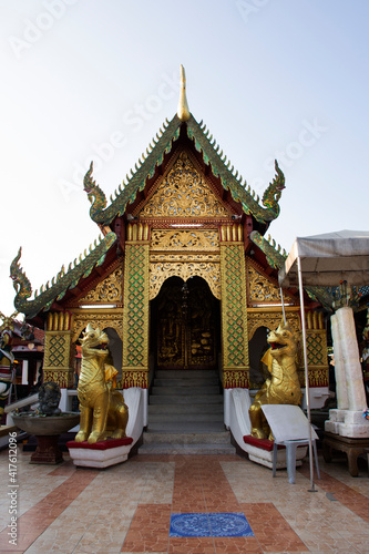 Ordination hall church or ubosot of Wat Phra That Doi Kham or Temple of the Golden Mountain for thai people and foreign travelers travel visit and respect praying at Mae Hia in Chiang Mai, Thailand