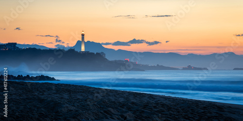 The Biarritz lighthouse at sunset,Atlantic ocean and beach in the foreground, in France photo