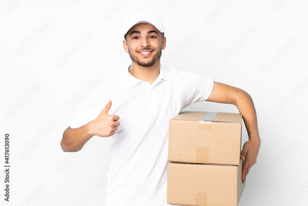 Delivery Arabian man isolated on blue background giving a thumbs up gesture Delivery Arabian man isolated on blue background giving a thumbs up gesture