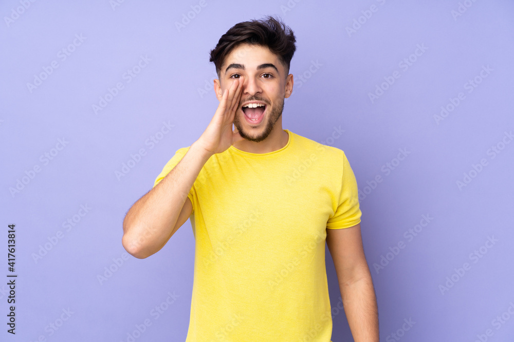 Arabian handsome man over isolated background shouting with mouth wide open Arabian handsome man over isolated background shouting with mouth wide open