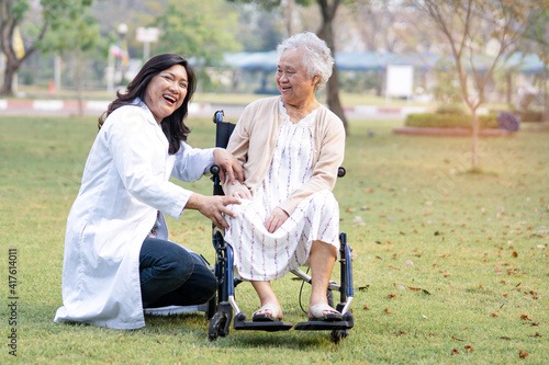 Doctor help and care Asian senior or elderly old lady woman patient sitting on wheelchair at park in nursing hospital ward; healthy strong medical concept