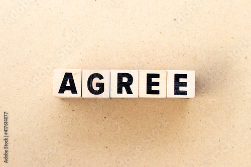 Letter block in word agree on wood background