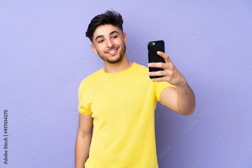 Arabian handsome man over isolated background making a selfie Arabian handsome man over isolated background making a selfie