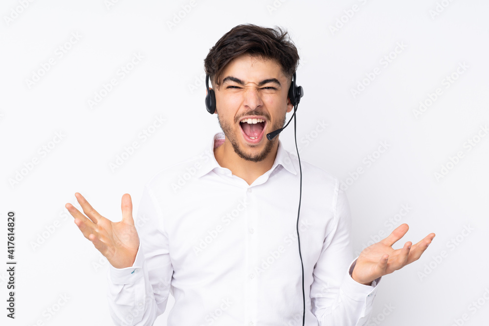 Telemarketer Arabian man working with a headset isolated on white background unhappy and frustrated with something