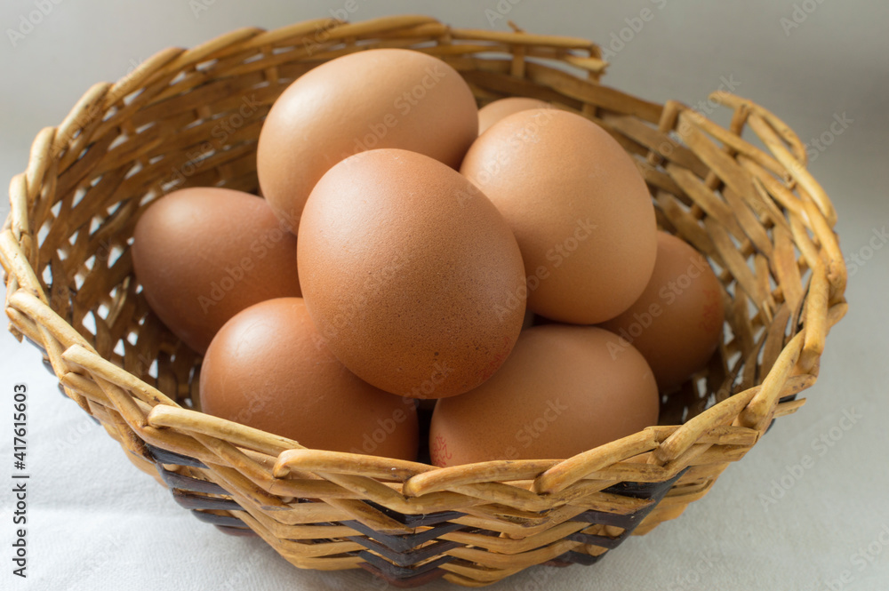 A group of eggs in a wicker basket A group of eggs in a wicker basket