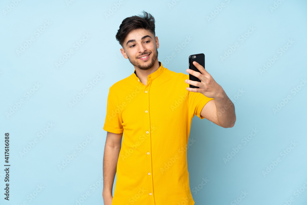 Arabian handsome man over isolated background making a selfie Arabian handsome man over isolated background making a selfie