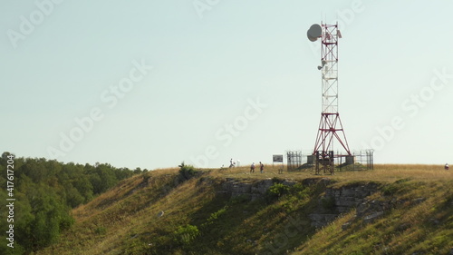 The radio station is in the mountains. The tower is installed for data transmission in the mountains.
