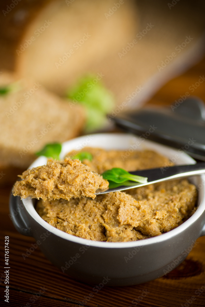 homemade meat pate in a ceramic bowl on a wooden table homemade meat pate in a ceramic bowl on a wooden table