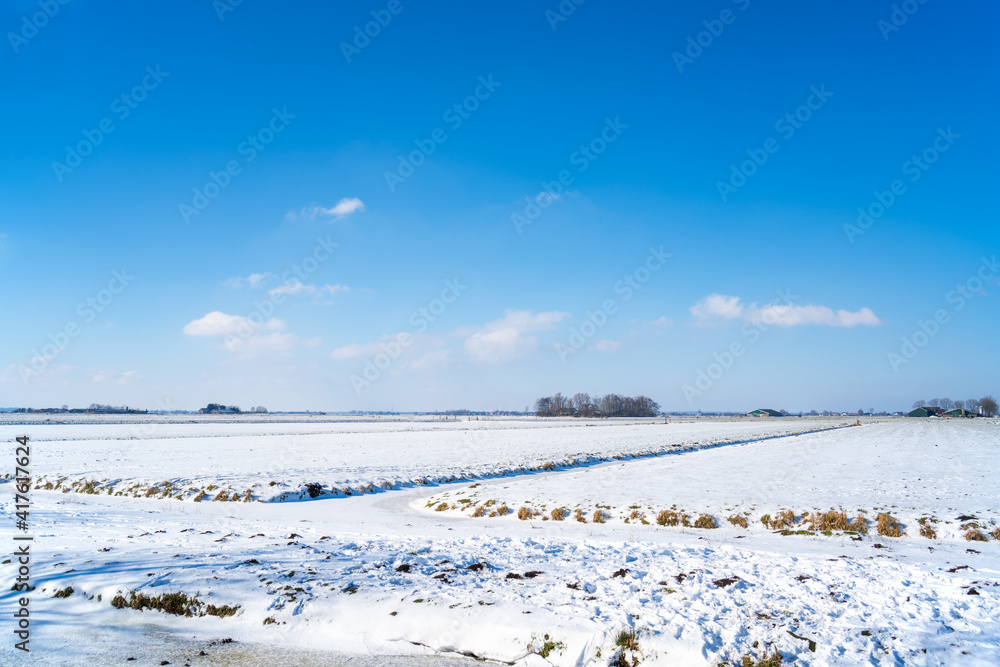 Rural landscape with snow and ice in the Netherlands
