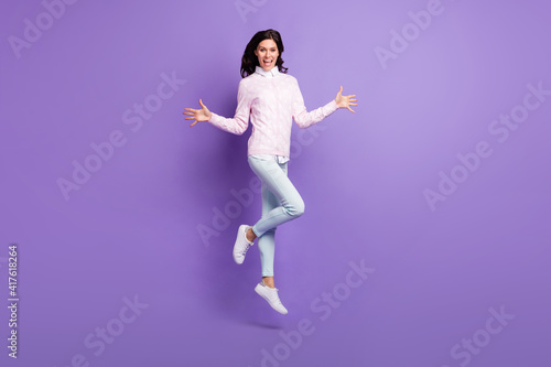 Fototapeta Naklejka Na Ścianę i Meble -  Full length body size view of lovely cheerful content wavy-haired girl jumping having fun isolated on violet color background