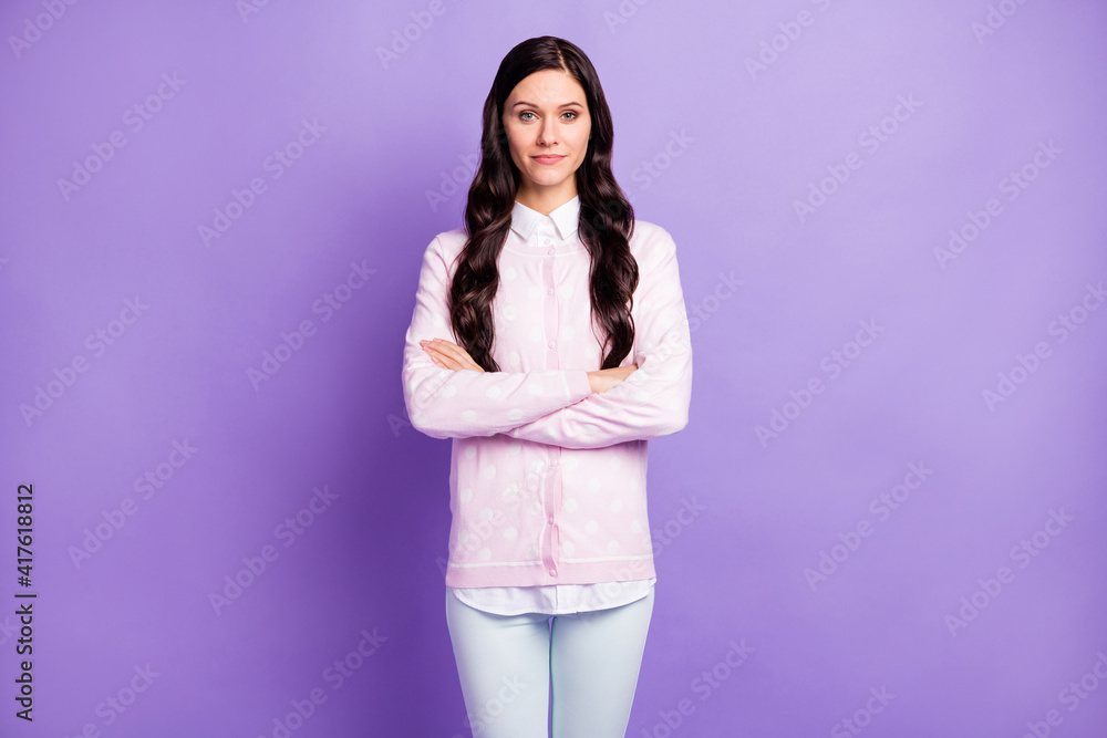 Portrait of pretty content wavy-haired girl wearing casual clothes folded arms isolated on violet color background Portrait of pretty content wavy-haired girl wearing casual clothes folded arms isolated on violet color background