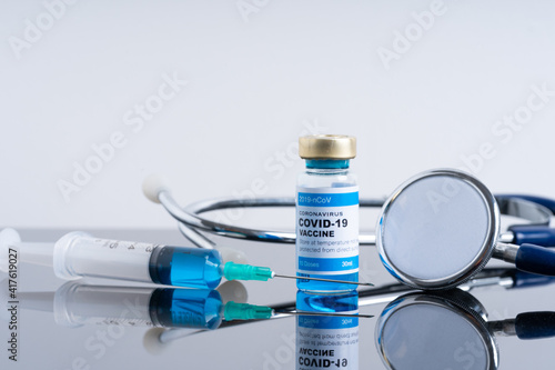Coronavirus vaccine with medical health care concept. Focused at syringe needle.