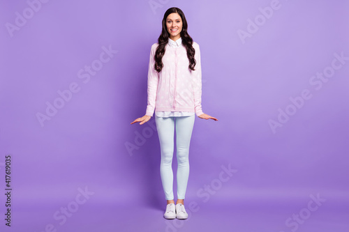 Full length body size view of pretty cheerful wavy-haired girl having fun posing isolated on violet color background