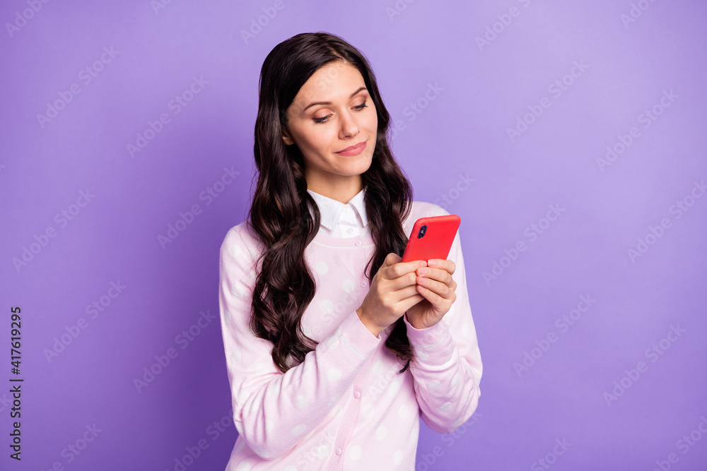 Portrait of lovely cheery wavy-haired girl holding in hand using device app 5g like isolated on violet color background Portrait of lovely cheery wavy-haired girl holding in hand using device app 5g like isolated on violet color background
