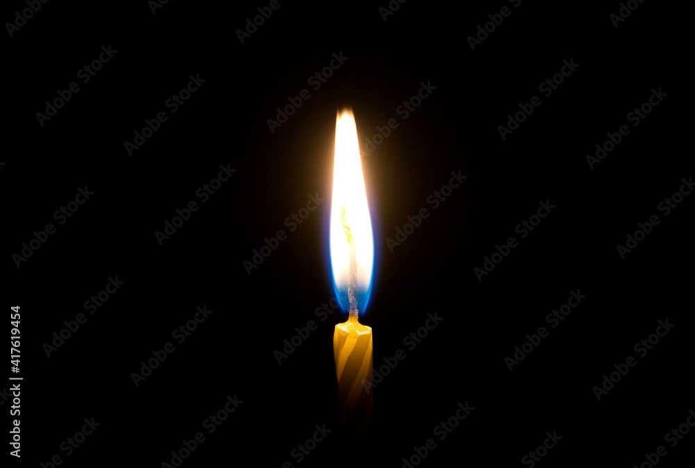 flames burning in the dark candle. close-up flames burning in the dark candle. close-up