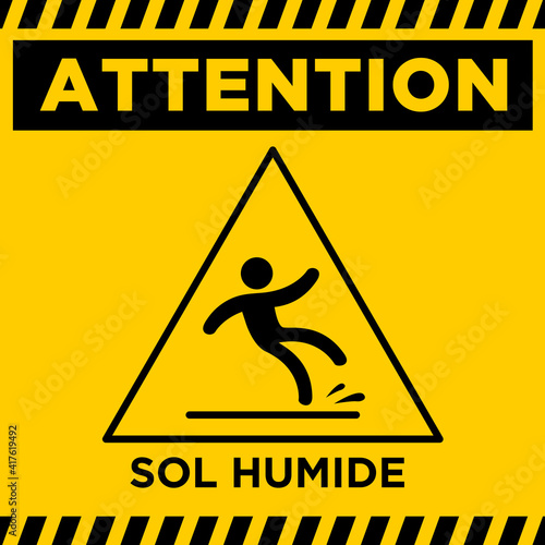 caution or danger wet floor in french attention sol humide
